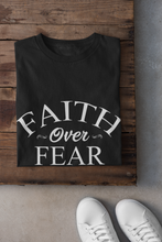 Load image into Gallery viewer, Wear this T-shirt with assurance, wear it like you mean it, wear it like you believe it, and be an inspiration. Faith Over Fear unisex t-shirt Classic t-shirt, fits both men and women (women consider choosing a size down if a more fitted look is desired) Soft and lightweight, with the right amount of stretch, comfortable and flattering for all. Pre-shrunk fabric, 100% combed and ring spun cotton For Print Care: wash cold, turn inside out, gentle cycle mild detergent, no fabric softener